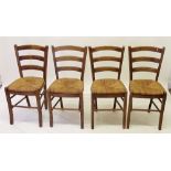A set of four pine rush seated kitchen chairs