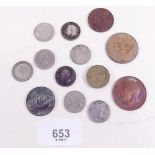 A small group of coins including sixpences