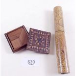 A small marquetry puzzle box - 5cm square and a treen scroll holder with penwork decoration- 15.5cm