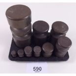 A brass set of metric weights on stand - 5g to 500g