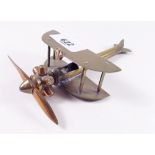 A brass Trench Art biplane, 13cm long