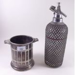 A vintage soda siphon and a silver plated bottle holder