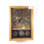 An oak chiming mantel clock