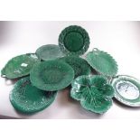 A quantity of green Majolica leaf plates including one by Wedgwood