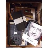 A box of Tag Heur and Chopard marketing and sales catalogues and Tag Heur mirror