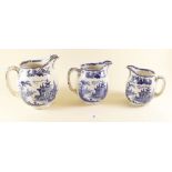 A set of three Doulton Madras graduated blue and white jugs and two bowls printed scenes after