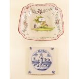 A French Faience fruit bowl painted figure and cottage within floral swags and an 18th century Delft