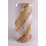 A large cylindrical white and amber glass vase