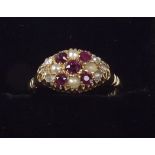 An Edwardian 18ct gold ruby, diamond and pearl set ring ,size N and a half.