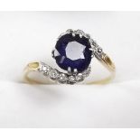 A gold sapphire and diamond set crossover ring , size Q.