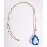 A Swiss blue topaz large pendant with gold mount and chain