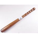 An antique turned wooden police truncheon