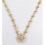 A heavy 18ct gold Kutchinsky necklace with diamond set flower form pendant on knotted chain,