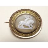 A Regency stone cameo brooch carved cherub riding a lion, set in gold oval frame with scrollwork