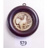 A 19th century continental carved horn circular miniature plaque of a bird, plaque - 4cm diameter