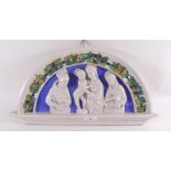 An Italian Della Robbia style pottery arched wall plaque "The Holy Family" - 41cm across