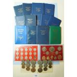 A quantity of coins in presentation cases including: (2) Isle of Man decimal coins 1975 and 1976 (2)