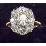 An 18ct gold ring set large diamond cluster, the central stone approx one carat, size N.
