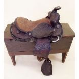 An American embossed leather childs saddle and stirrups