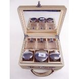 A 1950's vanity case fitted with glass toiletry bottles