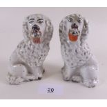 A pair of early Victorian Staffordshire spaniels with baskets - 11cm