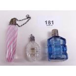 A pink miniature lattichino glass scent bottle and two other glass scent bottles