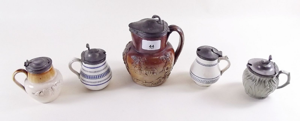 A collection of four stoneware pewter topped cruets and an 18th century stoneware hunting jug