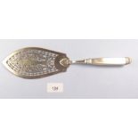 A 19th century Russian silver fish slice with pierced decoration of a fish within scrollwork and