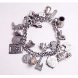 A silver charm bracelet and 21 silver and white metal charms