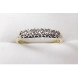A 9ct gold ring set seven graduated diamonds - total .33 cts , size P