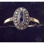 A 15ct gold diamond and cabochon sapphire cluster ring , size N .