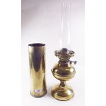 A brass oil lamp and a shell case