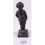 A miniature brass figure of a Belgian putti