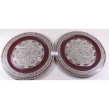 A pair of North African mother of pearl inlaid wooden plates - 30cm diameter