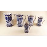 A set of blue and white graduated jugs