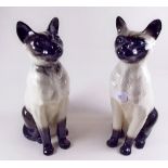 A pair of Siamese fireside cats, one by Doulton and one by Beswick - 35cm
