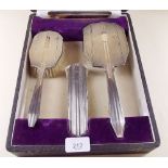 A silver four piece brush and mirror set - boxed