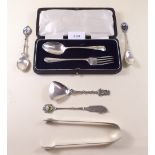 A pair of silver sugar tongs (36g), silver christening cutlery set (37g) boxed, and various silver