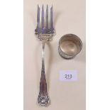 A Caldwell & Co sterling silver serving fork and a silver napkin ring, 1892, 88g total