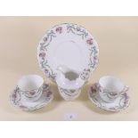 A Bridgwood tea service comprising: six cups and saucers, six tea plates, cake plate and jug