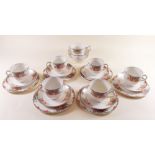 A 1930's tea service with floral decoration comprising six cups and saucers, six tea plates, sugar