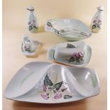 A 1950's set of Poole china comprising: dessert bowl and servers, butter dish, entree dish, cruet