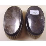 A pair of silver backed brushes