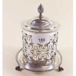 A silver plated biscuit box and lid with scrollwork decoration over glass liner by Hukin and Heath