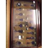 A quantity of glazed spoon racks and three early 20th century dark wood framed display cases
