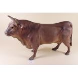 A large ceramic cow - possibly from a butchers shop display - 38cm long