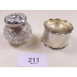 A cut glass and silver topped dressing table pot and a silver napkin ring