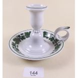 A Meissen porcelain chamberstick with green vine border