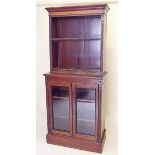 A 19th century mahogany two door glazed cabinet with associated mahogany open bookcase above