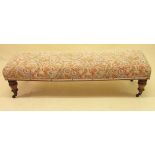 A Victorian upholstered window seat on turned supports,145cm long